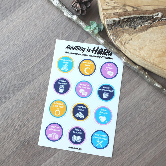 a sheet of stickers sitting on top of a wooden table